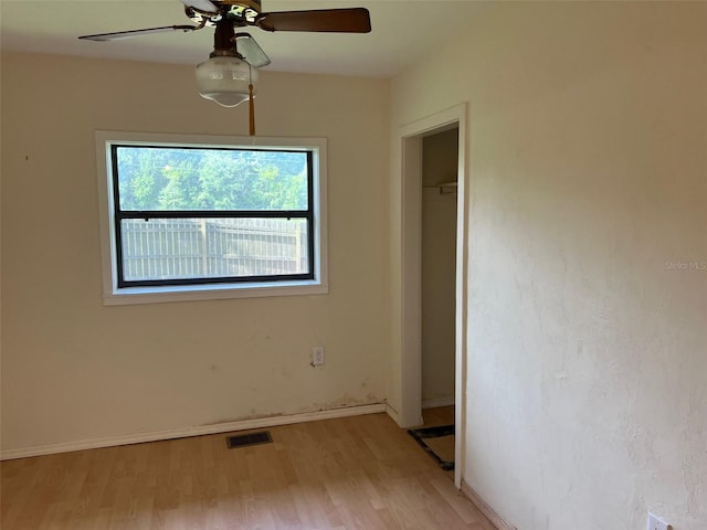 16431 NW US Highway 441, Alachua, FL 32615 - unfurnished bedroom featuring light wood finished floors, baseboards, ceiling fan, and a closet