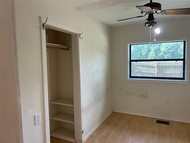 16431 NW US Highway 441, Alachua, FL 32615 - unfurnished bedroom featuring multiple windows, light wood-style floors, baseboards, and a closet