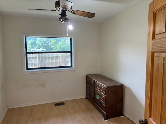16431 NW US Highway 441, Alachua, FL 32615 - unfurnished bedroom with light wood-style flooring, a ceiling fan, and baseboards