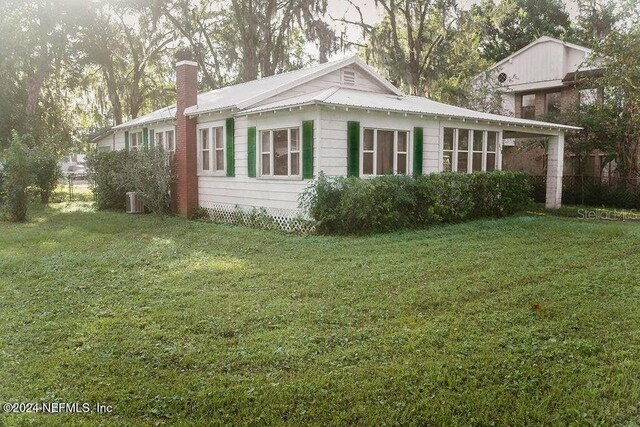 762 N Walnut St, Starke, FL 32091 - view of property exterior featuring a chimney