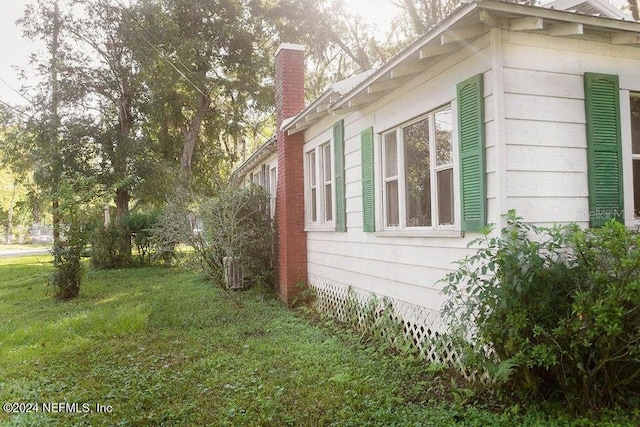 762 N Walnut St, Starke, FL 32091 - view of property exterior with a chimney and a yard