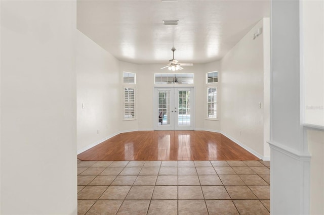 10303 SW 21st Ave, Gainesville, FL 32607 - unfurnished room featuring french doors, light tile patterned floors, ceiling fan, and baseboards