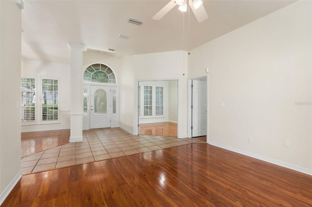 10303 SW 21st Ave, Gainesville, FL 32607 - spare room featuring wood-type flooring, ornate columns, ceiling fan, and baseboards