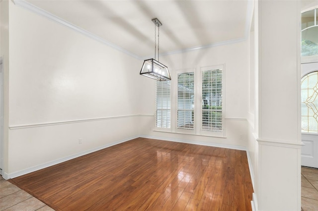 10303 SW 21st Ave, Gainesville, FL 32607 - unfurnished dining area featuring crown molding, baseboards, and wood finished floors