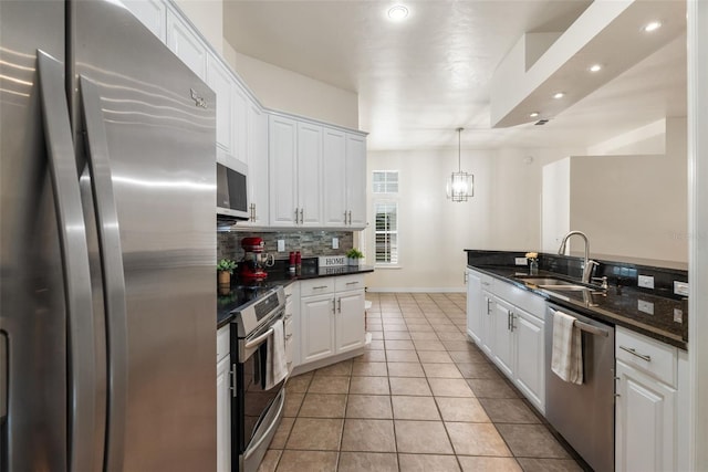10303 SW 21st Ave, Gainesville, FL 32607 - kitchen featuring stainless steel appliances, a sink, recessed lighting, white cabinetry, and tasteful backsplash