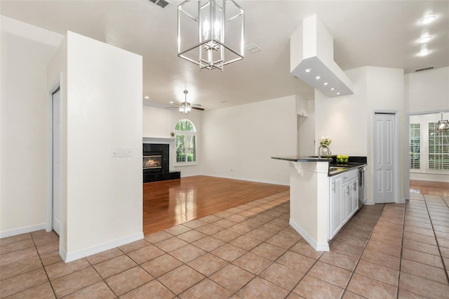 10303 SW 21st Ave, Gainesville, FL 32607 - kitchen with light tile patterned floors, a fireplace, healthy amount of natural light, and recessed lighting