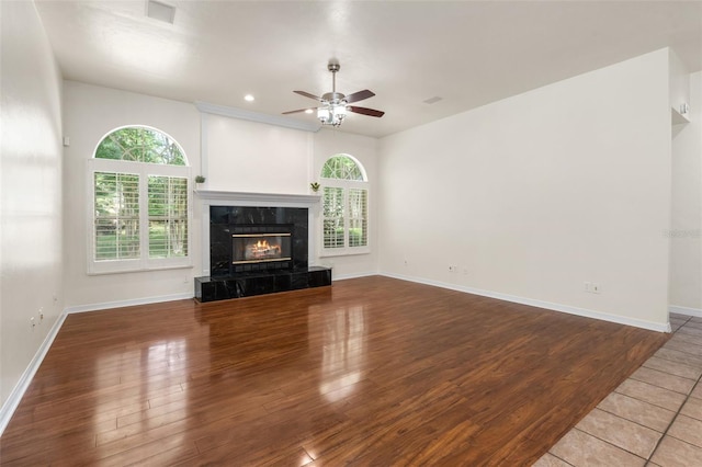 10303 SW 21st Ave, Gainesville, FL 32607 - unfurnished living room featuring a ceiling fan, healthy amount of natural light, wood finished floors, a fireplace, and recessed lighting
