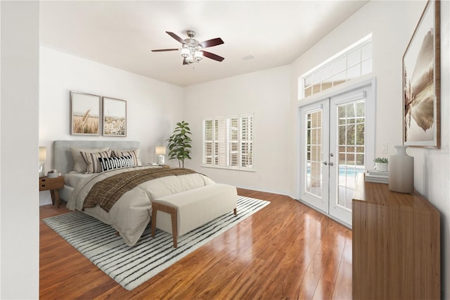 10303 SW 21st Ave, Gainesville, FL 32607 - bedroom with access to outside, french doors, wood finished floors, and a ceiling fan