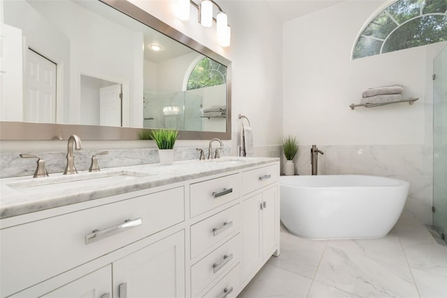 10303 SW 21st Ave, Gainesville, FL 32607 - full bath with double vanity, a freestanding bath, tile walls, a shower with door, and marble look tile flooring
