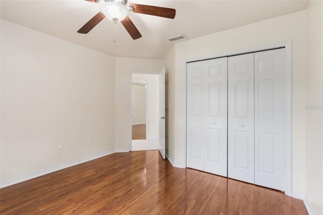 10303 SW 21st Ave, Gainesville, FL 32607 - unfurnished bedroom with wood finished floors, baseboards, a closet, and a ceiling fan