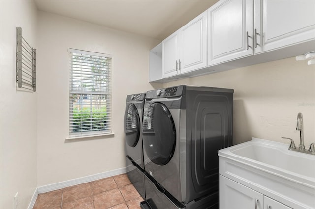 10303 SW 21st Ave, Gainesville, FL 32607 - laundry room featuring washer and dryer, cabinet space, baseboards, and light tile patterned floors