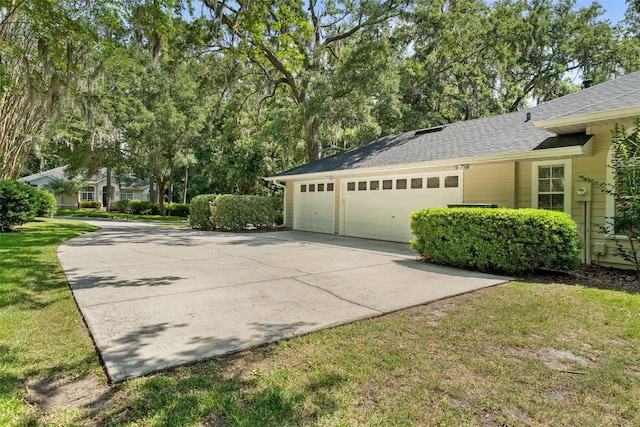 10303 SW 21st Ave, Gainesville, FL 32607 - view of home's exterior featuring a garage, concrete driveway, a shingled roof, and a lawn