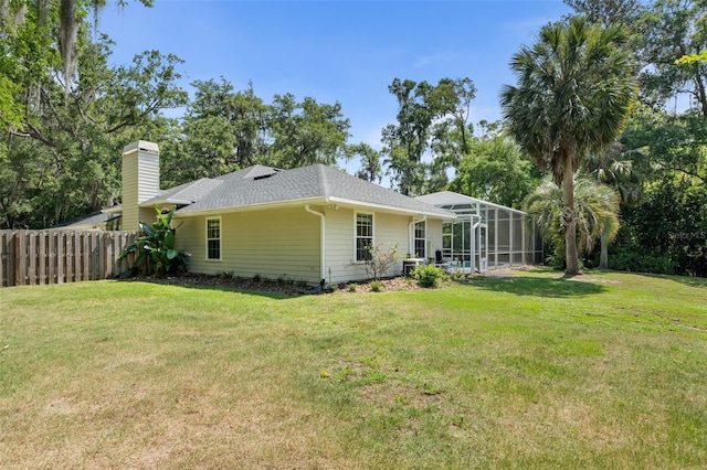 10303 SW 21st Ave, Gainesville, FL 32607 - back of house featuring a chimney, a lanai, and roof with shingles