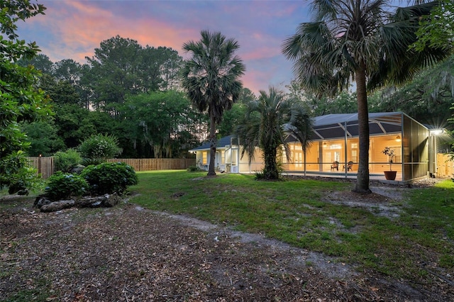 10303 SW 21st Ave, Gainesville, FL 32607 - yard at dusk featuring a lanai and a swimming pool