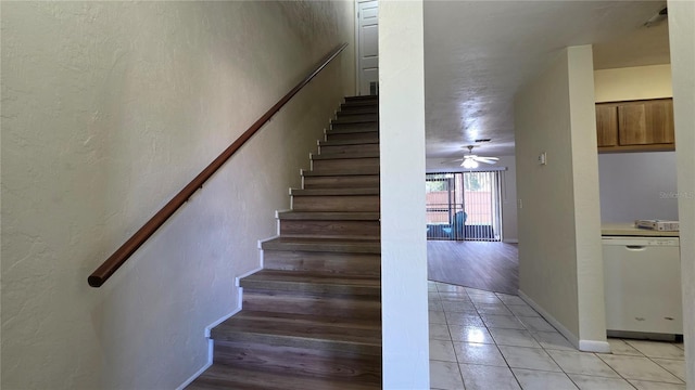 2635 SW 35th Pl Unit 1705, Gainesville, FL 32608 - staircase featuring tile patterned floors, ceiling fan, and baseboards