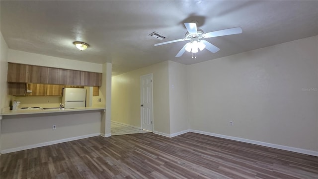 2635 SW 35th Pl Unit 1705, Gainesville, FL 32608 - unfurnished living room with wood finished floors, a ceiling fan, a sink, and baseboards