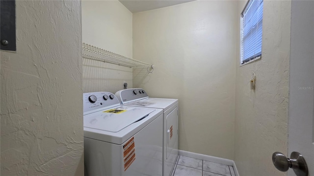 2635 SW 35th Pl Unit 1705, Gainesville, FL 32608 - laundry area with washing machine and clothes dryer, light tile patterned flooring, and baseboards