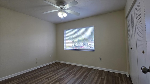 2635 SW 35th Pl Unit 1705, Gainesville, FL 32608 - unfurnished bedroom featuring a closet, dark wood-style flooring, baseboards, and ceiling fan