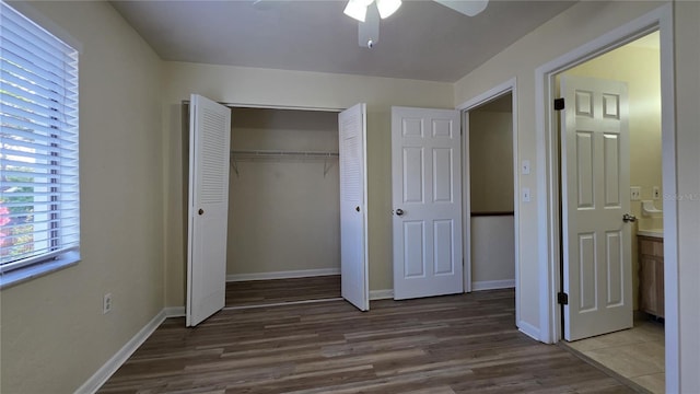 2635 SW 35th Pl Unit 1705, Gainesville, FL 32608 - unfurnished bedroom with wood finished floors, a closet, baseboards, and a ceiling fan