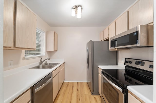 2360 SW Archer Rd Unit 204, Gainesville, FL 32608 - kitchen with stainless steel appliances, a sink, light brown cabinets, and light wood finished floors