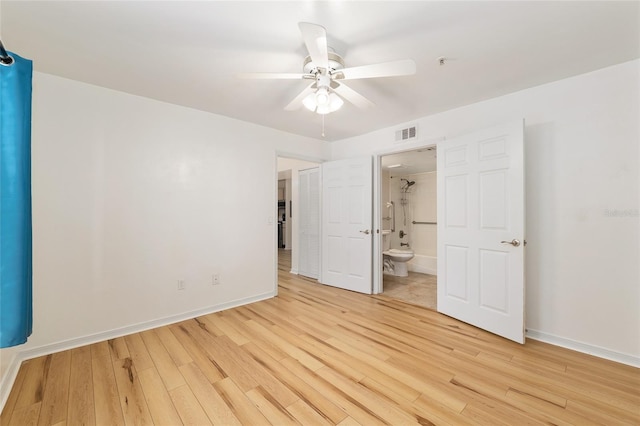 2360 SW Archer Rd Unit 204, Gainesville, FL 32608 - unfurnished bedroom with light wood finished floors, baseboards, and ensuite bath