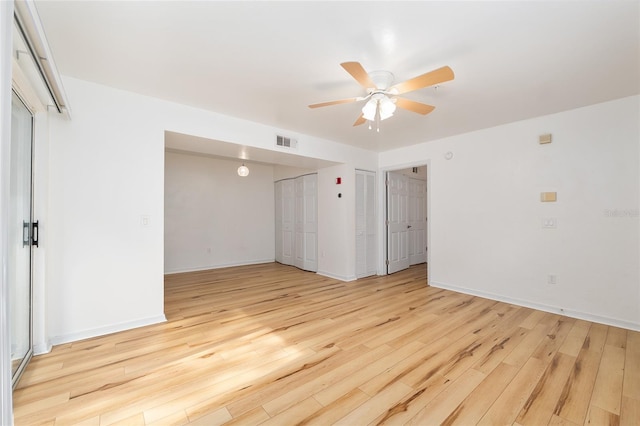2360 SW Archer Rd Unit 204, Gainesville, FL 32608 - spare room featuring a ceiling fan, light wood-type flooring, and baseboards