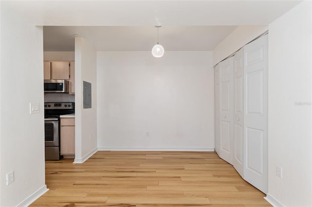 2360 SW Archer Rd Unit 204, Gainesville, FL 32608 - kitchen with appliances with stainless steel finishes, electric panel, light wood-style floors, and baseboards