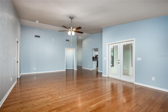 6425 NW 97th Ct, Gainesville, FL 32653 - empty room with a ceiling fan, lofted ceiling, french doors, wood finished floors, and baseboards