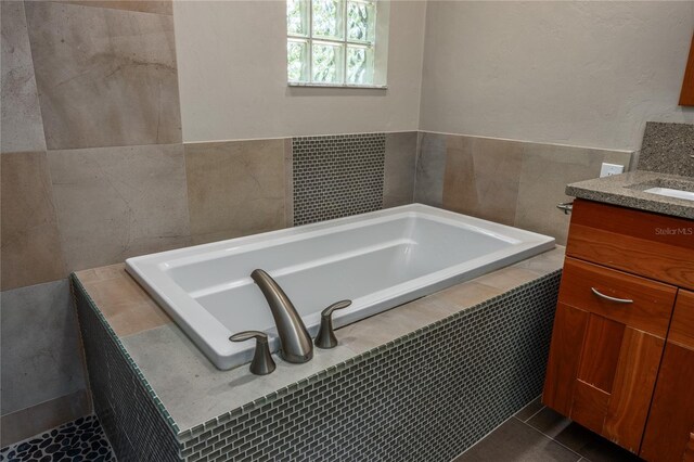 6425 NW 97th Ct, Gainesville, FL 32653 - bathroom featuring vanity, a bath, and tile patterned flooring