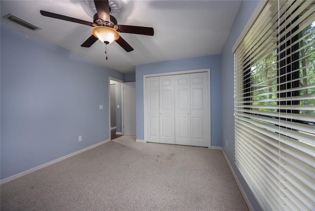 6425 NW 97th Ct, Gainesville, FL 32653 - unfurnished bedroom featuring light colored carpet, baseboards, a closet, and ceiling fan