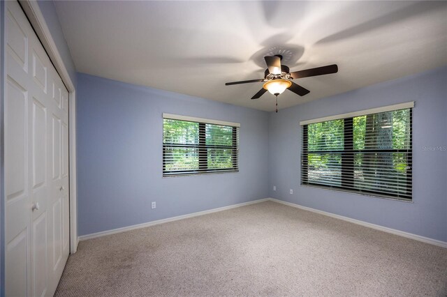 6425 NW 97th Ct, Gainesville, FL 32653 - unfurnished bedroom featuring a closet, carpet flooring, baseboards, and ceiling fan