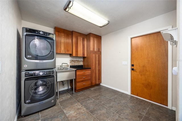 6425 NW 97th Ct, Gainesville, FL 32653 - washroom with stacked washer / drying machine, cabinet space, and baseboards