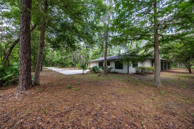 6425 NW 97th Ct, Gainesville, FL 32653 - view of yard featuring an attached garage and driveway