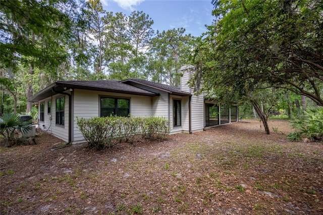 6425 NW 97th Ct, Gainesville, FL 32653 - view of side of home with a chimney