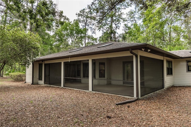 6425 NW 97th Ct, Gainesville, FL 32653 - rear view of property with a sunroom and a shingled roof