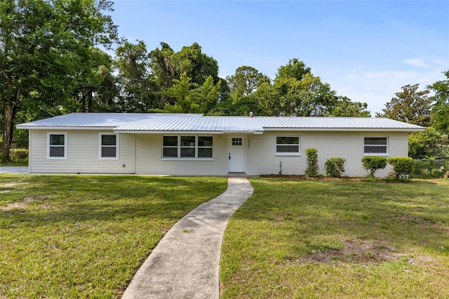 3237 NW 30th Ave, Gainesville, FL 32605 - ranch-style house featuring a front yard and metal roof
