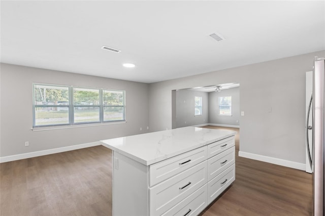 3237 NW 30th Ave, Gainesville, FL 32605 - kitchen with dark wood finished floors, freestanding refrigerator, baseboards, plenty of natural light, and recessed lighting