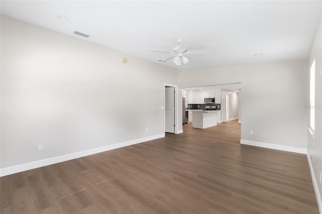 3237 NW 30th Ave, Gainesville, FL 32605 - unfurnished living room with a ceiling fan, baseboards, and wood finished floors
