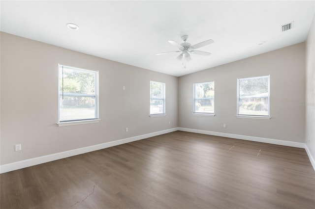 3237 NW 30th Ave, Gainesville, FL 32605 - unfurnished room featuring healthy amount of natural light, ceiling fan, baseboards, and wood finished floors