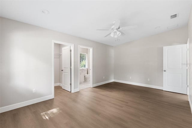 3237 NW 30th Ave, Gainesville, FL 32605 - unfurnished room featuring baseboards, a ceiling fan, and wood finished floors