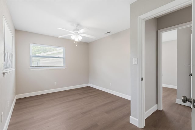 3237 NW 30th Ave, Gainesville, FL 32605 - unfurnished bedroom featuring wood finished floors, baseboards, and ceiling fan