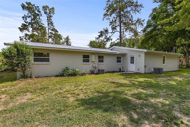 3237 NW 30th Ave, Gainesville, FL 32605 - rear view of house with cooling unit and a yard