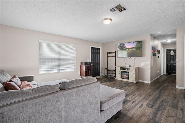 24 Sapphire Way, Ocala, FL 34472 - living room featuring dark wood-style flooring, a textured ceiling, baseboards, and healthy amount of natural light
