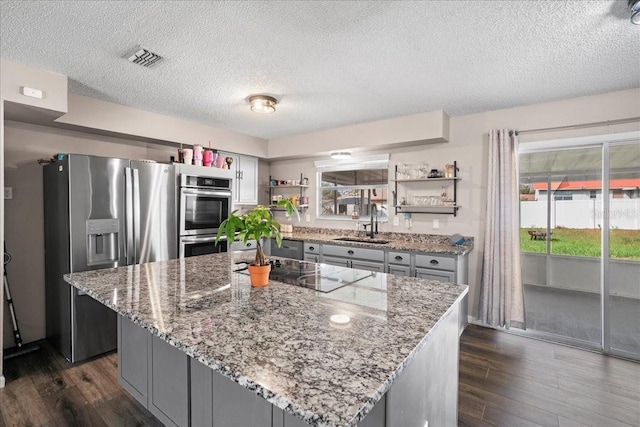 24 Sapphire Way, Ocala, FL 34472 - kitchen featuring open shelves, appliances with stainless steel finishes, gray cabinets, a sink, and dark wood-style floors