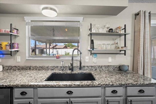 24 Sapphire Way, Ocala, FL 34472 - kitchen with a sink, open shelves, gray cabinetry, and light stone countertops