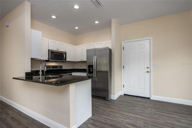 15217 NW 134th Ter, Alachua, FL 32615 - kitchen featuring stainless steel appliances, a peninsula, baseboards, white cabinetry, and dark wood-style floors