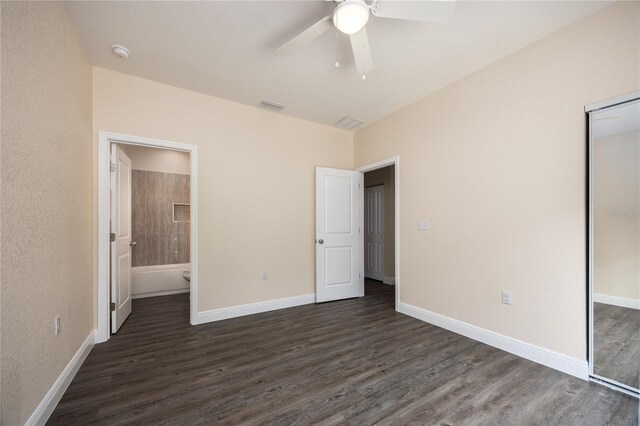 15217 NW 134th Ter, Alachua, FL 32615 - unfurnished bedroom featuring dark wood finished floors, a closet, baseboards, and ceiling fan