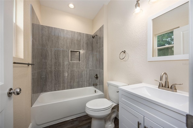 15217 NW 134th Ter, Alachua, FL 32615 - bathroom featuring toilet, vanity, shower / tub combination, a textured wall, and wood finished floors