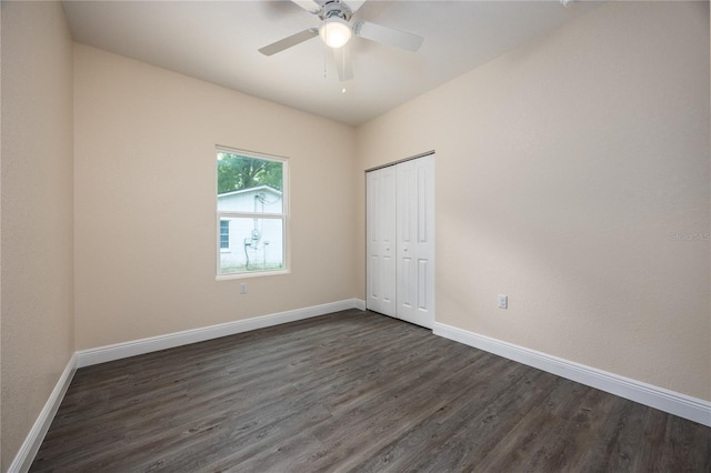 15217 NW 134th Ter, Alachua, FL 32615 - unfurnished bedroom with dark wood-type flooring, baseboards, a closet, and a ceiling fan