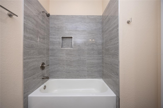 15217 NW 134th Ter, Alachua, FL 32615 - full bathroom featuring shower / bath combination and a textured wall